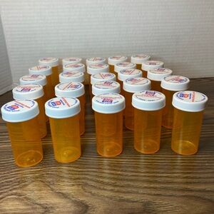 Lot of 25 empty orange plastic prescription bottles approx. 3” tall, 1.5 wide.